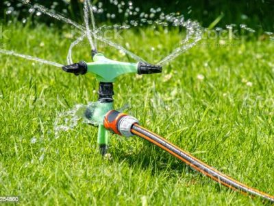 Sprinkler of automatic watering system working in the hot summer.